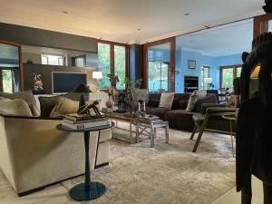 a living room with a couch and a table at The Ridgeback, 4 Bedroom Good Living, Bryanston in Johannesburg