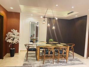 a dining room with a table and chairs at 2 - 4 bedroom apartments in Eko Atlantic City in Lagos +21 photos