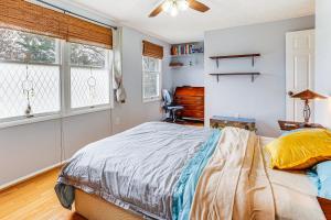 a bedroom with a bed and a desk and windows at Near Trails, Parks and Orchards Germantown Retreat in Germantown