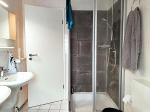 a bathroom with a shower and a sink at Meeresfeeling in Horumersiel in Horumersiel