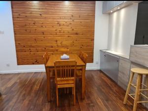 a dining room with a wooden table and chairs at Lucky 7 Homestay - Utama Court in Sandakan +2 photos