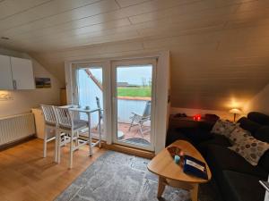 a living room with a couch and a table at Meeresfeeling in Horumersiel in Horumersiel