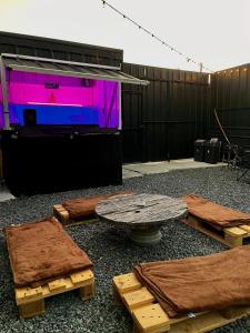 a stage with a table and a purple screen at Boxify Cabins 