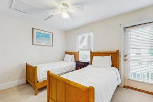 a bedroom with two beds and a ceiling fan at Barrier Dunes Hideaway in Oak Grove +31 photos