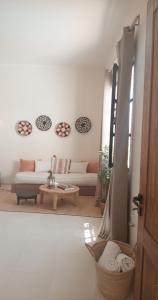 a living room with a couch and a table at Suites white house in Essaouira
