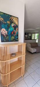 ein Wohnzimmer mit einem Flachbild-TV auf einem Holzständer in der Unterkunft Refuge tropical entre mer et nature à Sainte-Rose Guadeloupe in Sainte-Rose