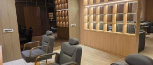 a waiting room with chairs and a mirror at MoonBasa Boutique Hotel and Spa Infopark , Kakkanad in Cochin
