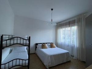 een slaapkamer met twee stapelbedden en een raam bij Casa Vacanze Ilenia in Marina di Montemarciano