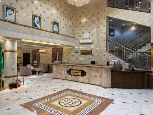 a large lobby with a counter in a building at شقق الاوفاز للشقق المخدومة--إقتصادي in Qal'at Bishah +5 photos