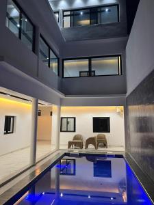 a house with a swimming pool with two chairs at Beautiful Modern Villa in Mbour