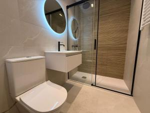 a bathroom with a toilet and a sink and a shower at YBH Atlantic Boutique in Vigo +91 photos