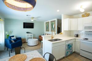 a kitchen with a sink and a living room at AK Getaway Too ,where the waves the shore and worries melt away. in Port Aransas
