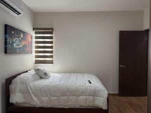 Ένα ή περισσότερα κρεβάτια σε δωμάτιο στο Depa A unas calles de la Playa y Zona Dorada ByGPS +44 φωτογραφίες