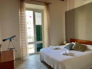a bedroom with a bed with a camera and a window at Jacuzzi Suite in Livorno