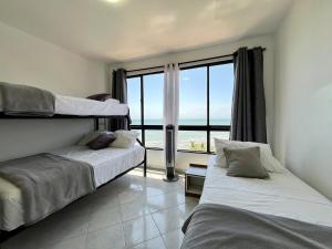 Postel nebo postele na pokoji v ubytování Rio Mar Suites Tucacas + 32 fotografií