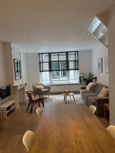 a living room with a couch and a table at Koningshof XL in Alkmaar