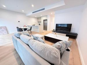 a living room with a couch and a table at Cosy Convenience 2BR APT in Castle Hill in Castle Hill