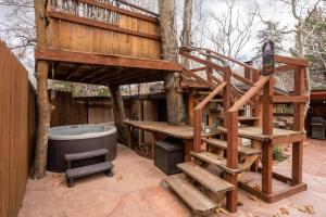 a tree house with a ladder and a hot tub at 47 Creekside Retreat House in Sedona