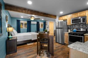 a kitchen and living room with a bed and a refrigerator at 15 Creekside Retreat in Sedona +26 photos