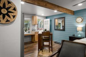 a kitchen with blue walls and a table and a clock at 15 Creekside Retreat in Sedona