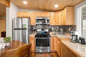 a kitchen with wooden cabinets and stainless steel appliances at 18 Creekside Retreat in Sedona