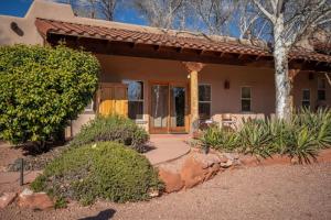 a home with a front porch and a patio at Adobe Hacienda - Baja Suite in Oak Creek