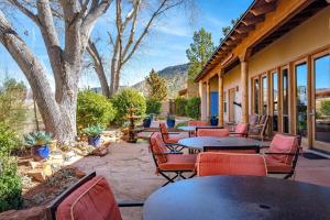 a patio with tables and chairs and trees at Adobe Hacienda - Baja Suite in Oak Creek