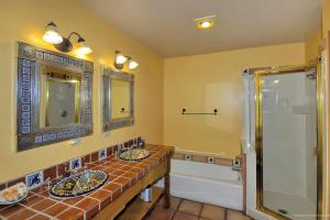 a bathroom with two sinks and a shower at Adobe Hacienda - Anasazi Suite in Oak Creek