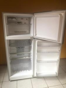 an empty refrigerator with its door open in a kitchen at Cabañas Mami Kiki in Panguipulli