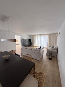 a living room with a couch and a table and chairs at Casa Jable Mozaga in Mozaga