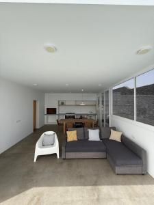 a living room with a couch and a table at Casa Jable Mozaga in Mozaga