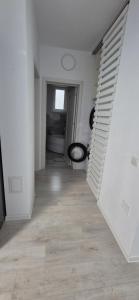an empty hallway with white walls and wooden floors at Szabo Georgiana in Alba Iulia
