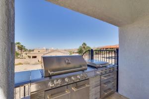 a grill on a balcony with a view at 4 Mi to Dtwn Luxe Gem with Pool in Lake Havasu City in Lake Havasu City