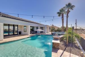 a swimming pool in front of a house with palm trees at 4 Mi to Dtwn Luxe Gem with Pool in Lake Havasu City in Lake Havasu City