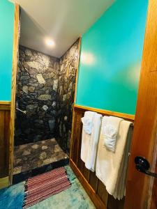 a bathroom with towels hanging on a wall at Howler Landing Vacation Rental in Bermudian Landing