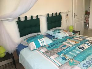 a bedroom with a bed with two pillows at La Maison d'Abigaelle in Le François