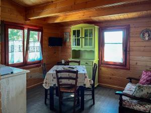 un comedor con una mesa en una cabaña en Bosco D'Olmi Country House, en SantʼAndrea del Garigliano