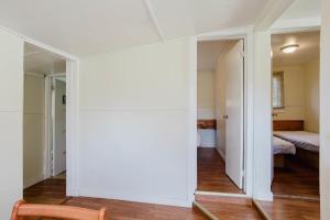 a room with a door leading to a bedroom at 2-Bedroom Cottage #5 - Lodgepole Pine in Gravenhurst