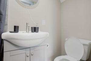 ein weißes Badezimmer mit Waschbecken und Toilette in der Unterkunft Studio Cottage in Pine Lake #6 in Gravenhurst