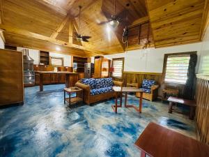 a living room with a couch and a table at Howler Landing Vacation Rental in Bermudian Landing