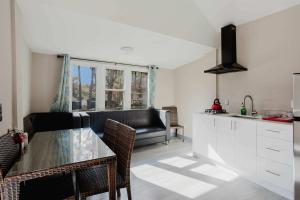 a kitchen and living room with a table and a couch at 3-Bedroom Cottage #7 - Austrian Pine in Gravenhurst