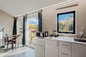 eine Küche mit Tisch und Mikrowelle in der Unterkunft Studio Cottage #8 - Jack Pine in Gravenhurst