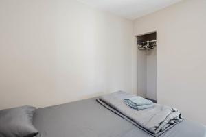 Ce lit se trouve dans un dortoir blanc doté d'une couverture. dans l'établissement 2-Bedroom Cottage #10 - Pitch Pine, à Gravenhurst