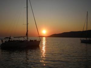 a sail boat in the water at sunset at Marathon Eco Stay in Marathon