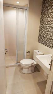 a bathroom with a toilet and a shower and a sink at Cityscape Bliss Phuket in Ban Sam Kong