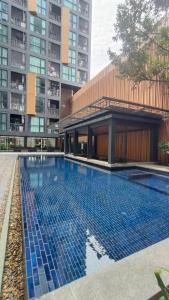 a swimming pool in the middle of a building at Cityscape Bliss Phuket in Ban Sam Kong