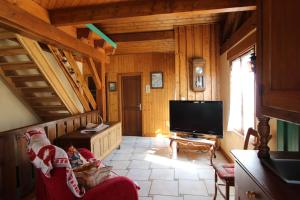 a living room with a flat screen tv in a cabin at La 2 CV Verte in Lesseux