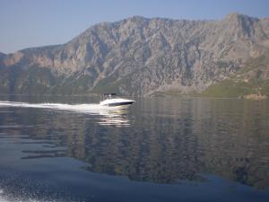 a boat on the water with mountains in the background at Marathon Eco Stay in Marathon