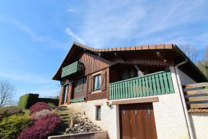 a house with a balcony on top of it at La 2 CV Verte in Lesseux