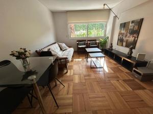 a living room with a couch and a table at Bicentenario Park Apartment in El Cerrillo +15 photos